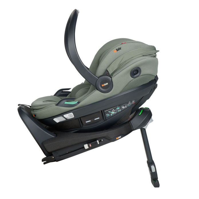Side profile of BeSafe Beyond Isofix Base with support leg extended and cradling a BeSafe Go Beyond2 infant car seat in Meadow Green SoftBreeze fabric, available from Parent Studio.