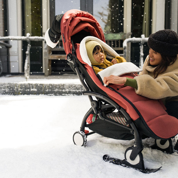 Stokke YOYO stroller in snow with black skis attached to front wheels - Available from Parent Studio