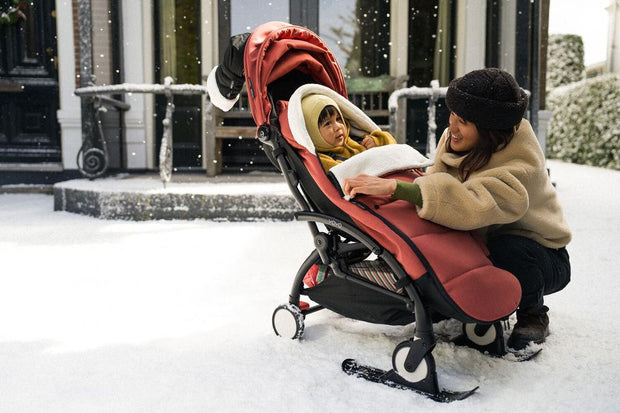 Stokke YOYO stroller in snow with black skis attached to front wheels - Available from Parent Studio