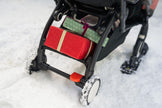 Stokke YOYO stroller gliding smoothly over snow with black skis attached to front wheels - Available from Parent Studio