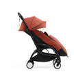 Side profile of the Stokke YOYO5 Stroller and Footmuff in Berry with integrated leg rest, available from Parent Studio.