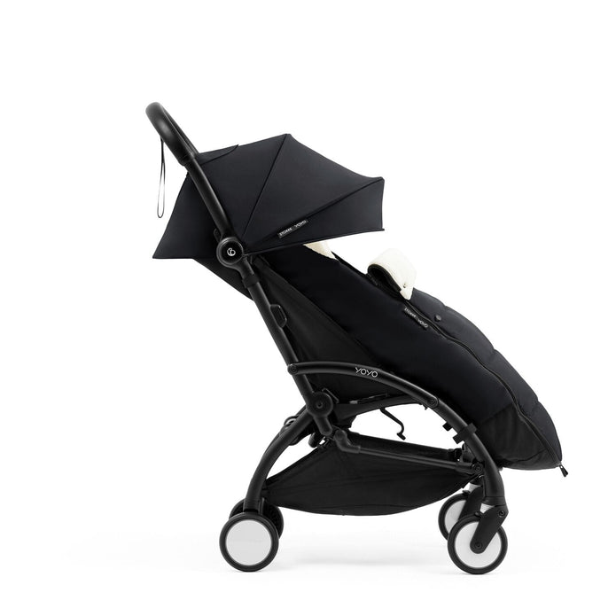 Side profile of the Stokke YOYO5 Stroller and Footmuff in Black with integrated leg rest, available from Parent Studio.