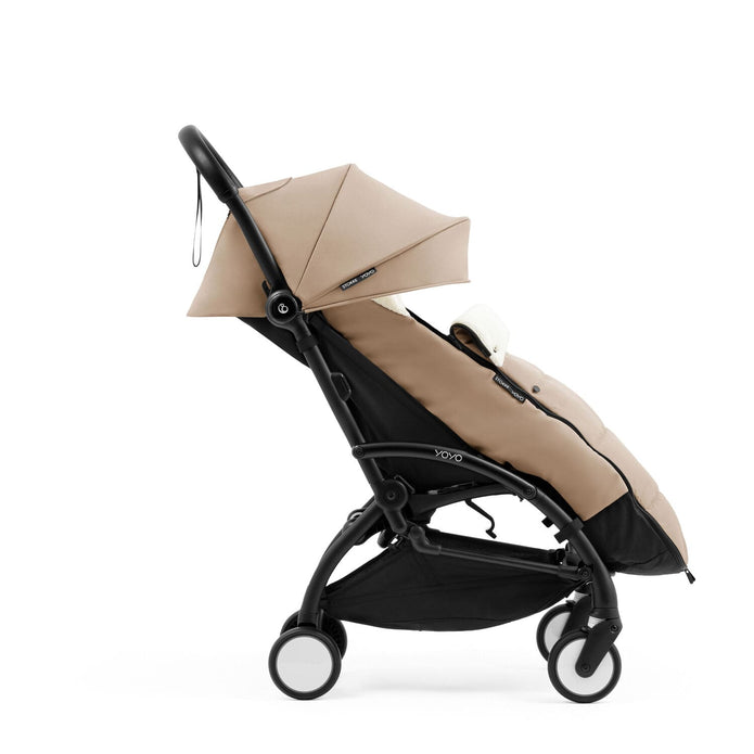 Side profile of the Stokke YOYO5 Stroller and Footmuff in Taupe with integrated leg rest, available from Parent Studio.