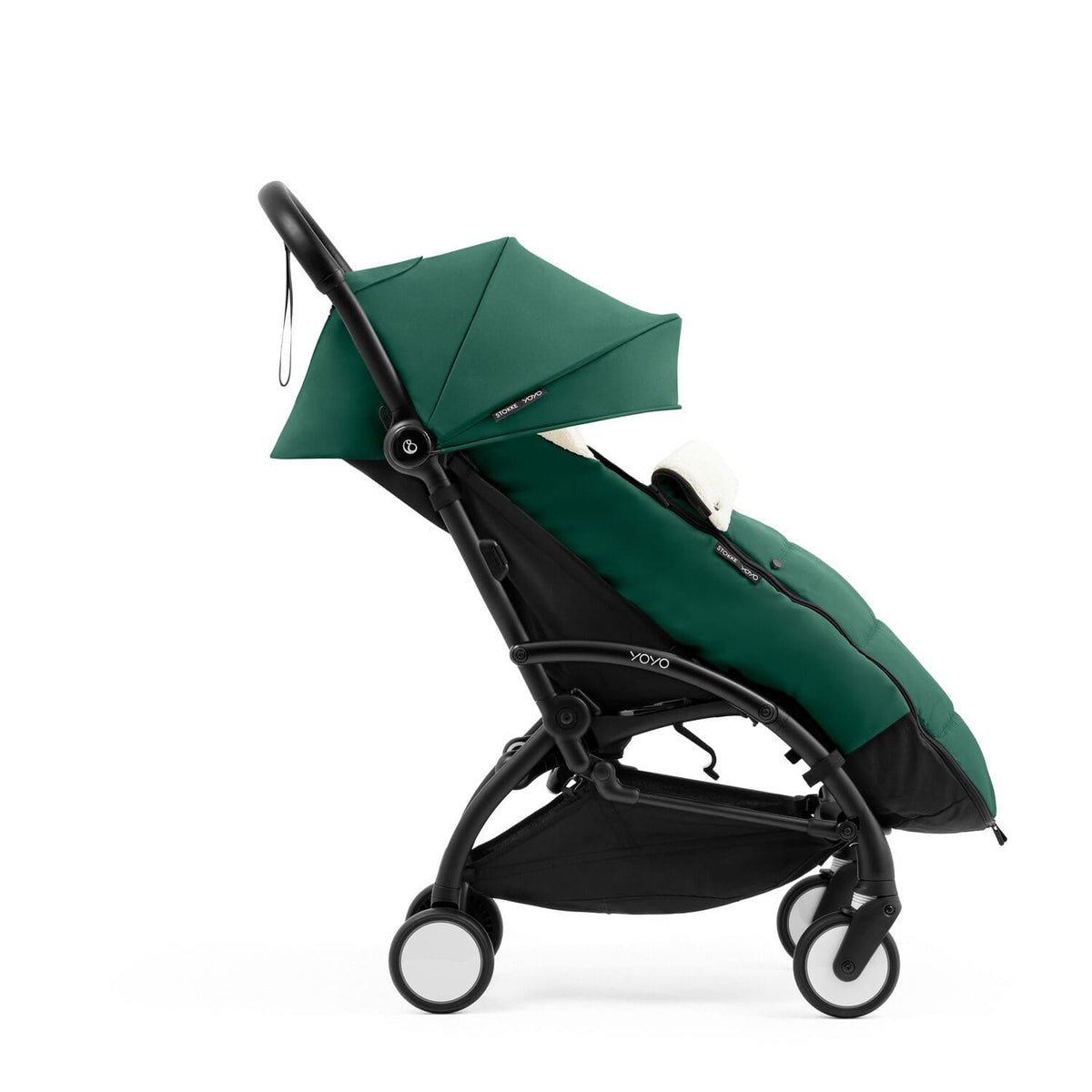 Side profile of the Stokke YOYO5 Stroller and Footmuff in Forest Green with integrated leg rest, available from Parent Studio.