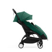 Side profile of the Stokke YOYO5 Stroller and Footmuff in Forest Green with integrated leg rest, available from Parent Studio.