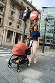Stokke YOYO5 stroller fitted with Berry Newborn Pack in urban setting - Available from Parent Studio