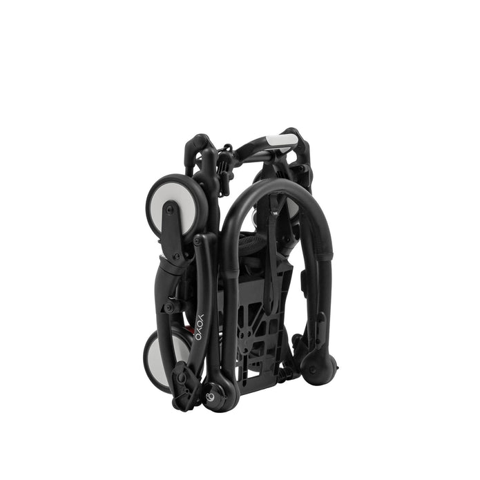Three-quarter angled perspective of the folded Stokke YOYO5 chassis showing its cabin-approved compact footprint - Available from Parent Studio