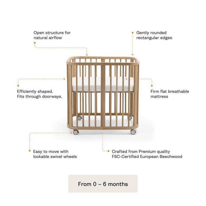 Stokke Nighti mini cot in Natural Beechwood with Stokke accessories including the mattress and wheels set for mobility with features explained — Available from Parent Studio