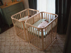The Stokke Nighti Mini in use as a sibling co-sleeper for newborn twins — Available from Parent Studio