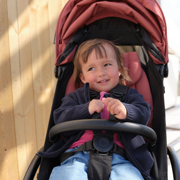 Stokke YOYO toddler bumper bar on Berry YOYO5 stroller in lifestyle image- Available from Parent Studio