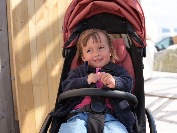 Stokke YOYO toddler bumper bar on Berry YOYO5 stroller in lifestyle image- Available from Parent Studio