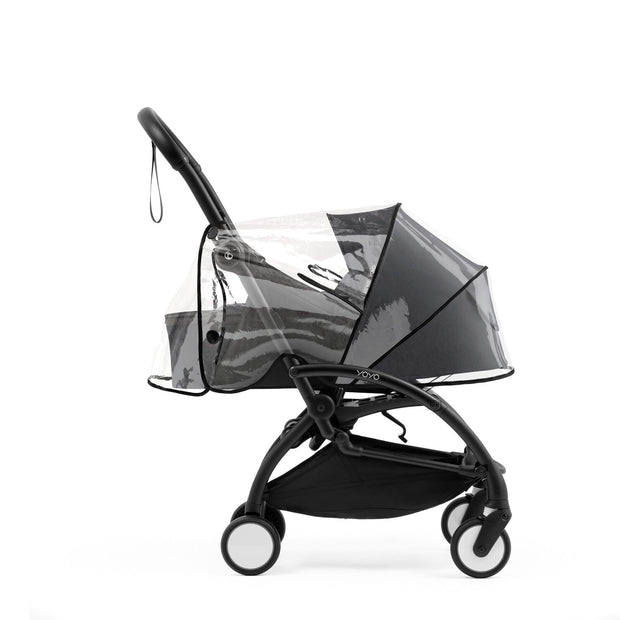 Transparent rain cover secured over a Black YOYO5 newborn pack on a Yoyo5 base frame - Available from Parent Studio