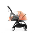 Transparent rain cover secured over a Peach YOYO5 newborn pack on a Yoyo5 base frame - Available from Parent Studio