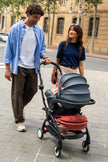 Front view of the Stokke YOYO5 chassis transformed into a travel system with a parent-facing Maxi-Cosi car seat - Available from Parent Studio