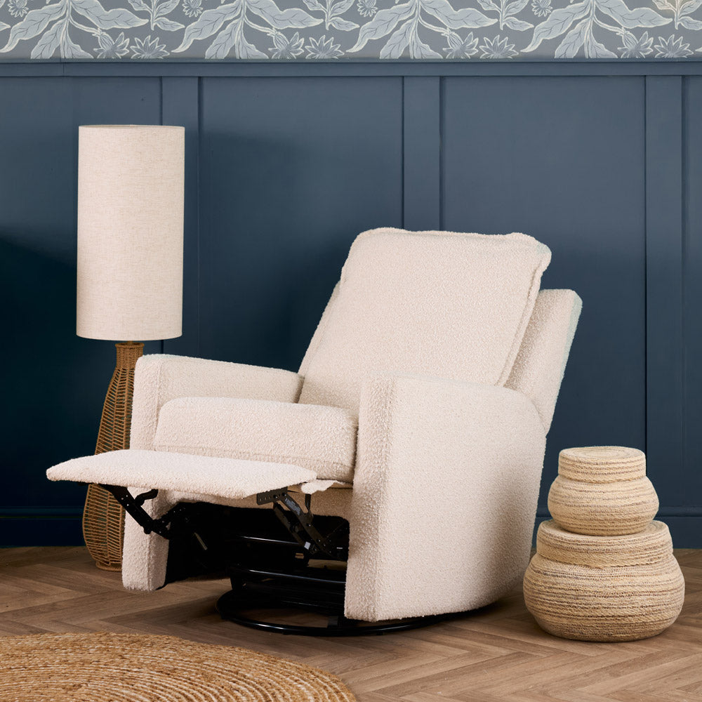 Beige recliner chair in a room with a blue wall and decorative elements.
