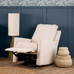 Beige recliner chair in a room with a blue wall and decorative elements.