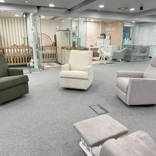 Obaby Maddison nursing chairs Modern living room with gray and white furniture in a showroom setting.