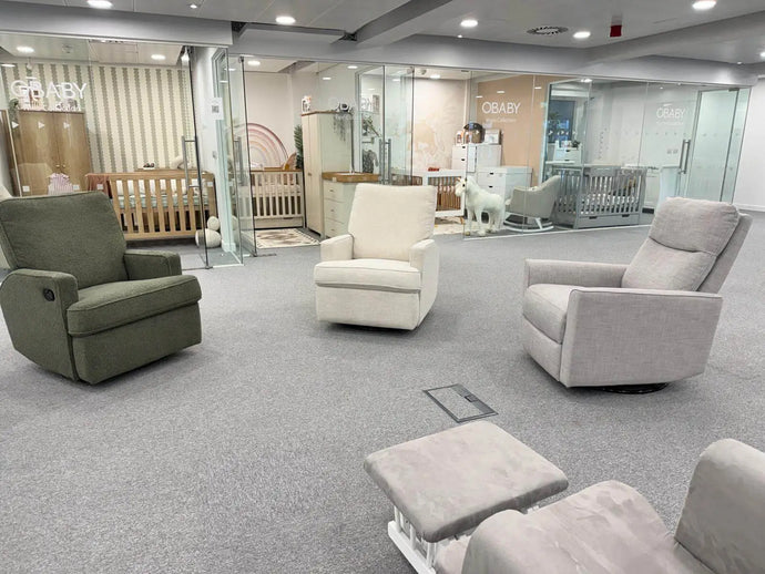 Obaby Maddison nursing chairs Modern living room with gray and white furniture in a showroom setting.
