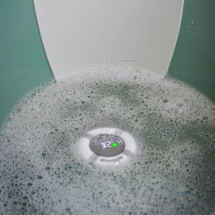 Shnuggle Bobbin Buoy thermometer inside a Shnuggle baby bath — Available from Parent Studio.
