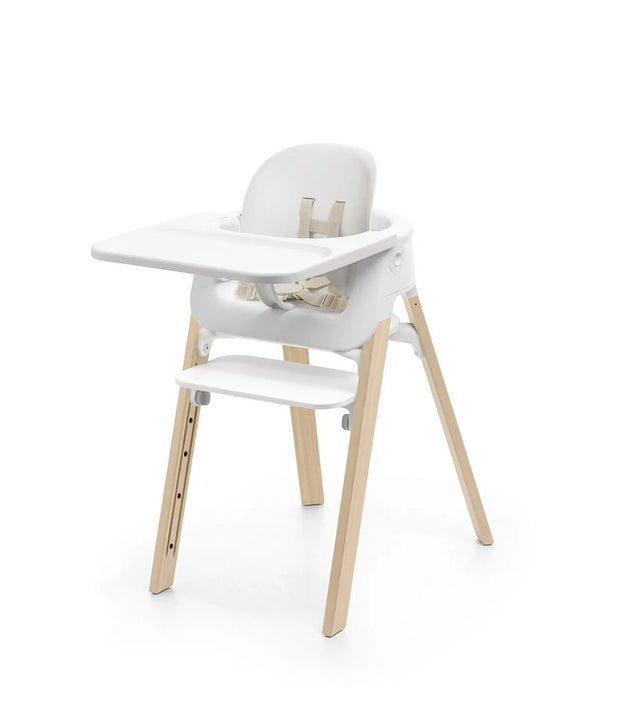 White high chair with wooden legs on a white background