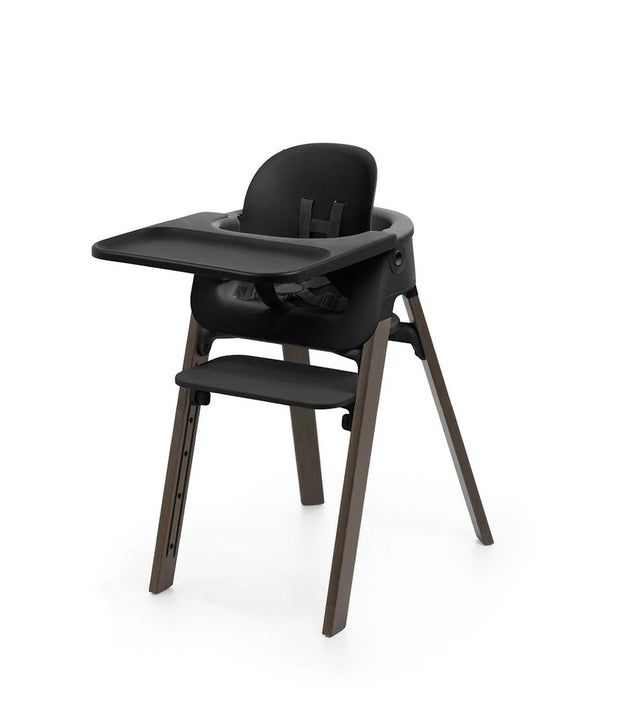 Black high chair with tray on a white background