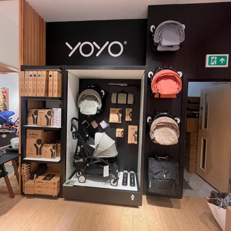Stokke YOYO Stroller display with strollers and Besafe car seats in a store setting.