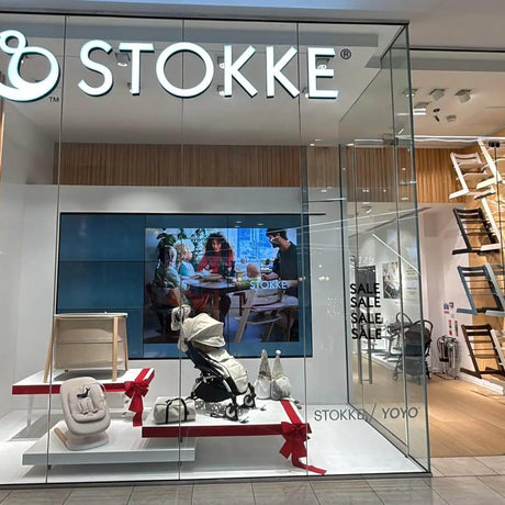Stokke store front with display of products and 'STOKKE' branding.