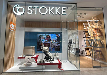 Stokke store front with display of products and 'STOKKE' branding.