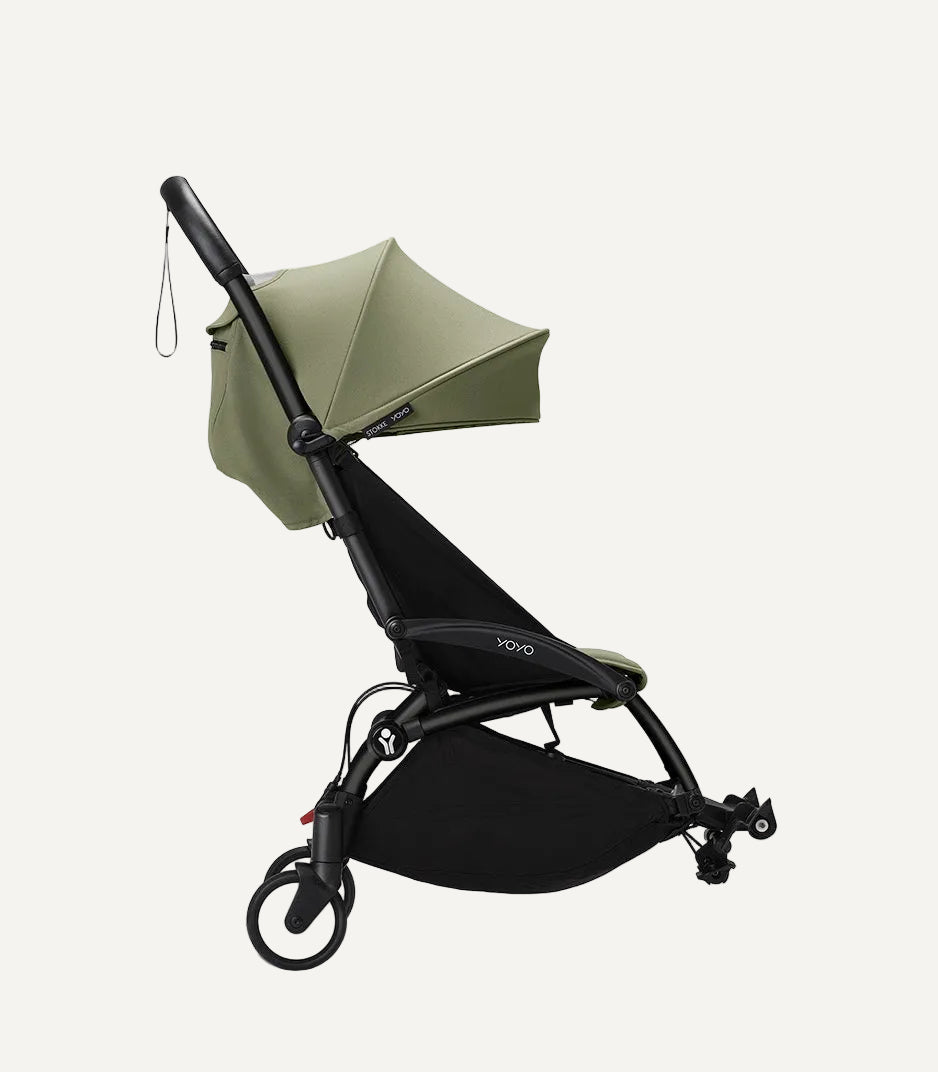 Green umbrella with black frame on a white background